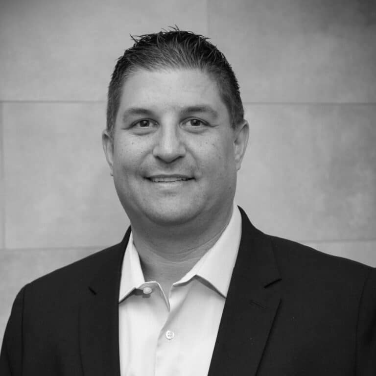 A black and white photo of a man in a suit.